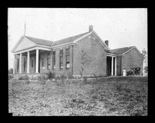 Mrs. Nannie Faulconer standing outside Picadome school house