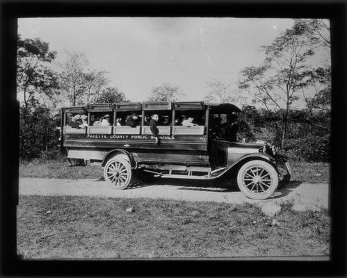 Early motor bus carrying students to school
