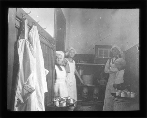 Kitchen help preparing soup from a converted cloak room at Loradale School