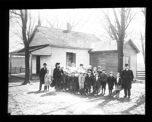 Locust Grove student in front of school and kitchen addition with Ms. Nannie Faulconer, Dr. F.C. Button, rural school supervisor, and teacher, Miss Grace Yocum