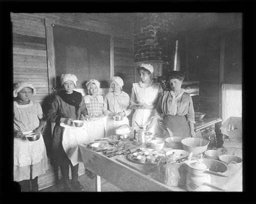 Students in Locust Grove kitchen with Mrs. Nannie Faulconer and teacher, Miss Grace Yocum. Kitchen with results of kitchen shower given for the school