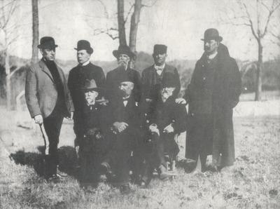 Group of men; written on the back of the photo (imaged on the same sheet of photostat) 