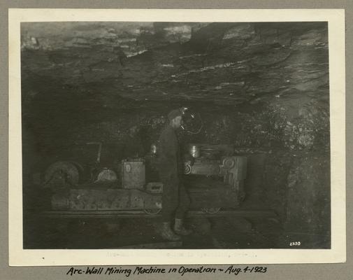Title handwritten on photograph mounting: Arc-Wall Mining Machine in Operation