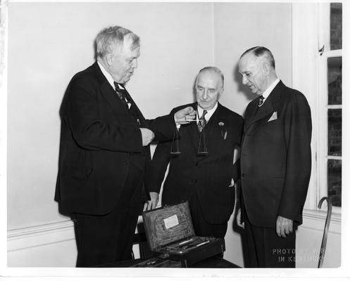 Dr. McCormick, Head of the State Dept. of Health, tries one of the scales used by Dr. McDowell