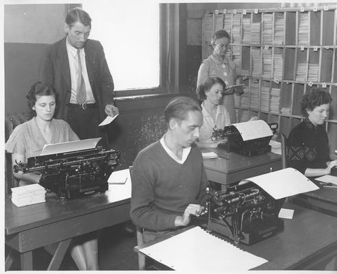 Valuable public records are typed from loose index cards to permanent ledger sheets by WPA workers