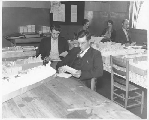 WPA workers alphabetize index cards in county courthouse before writing them in permanent record books in twenty counties