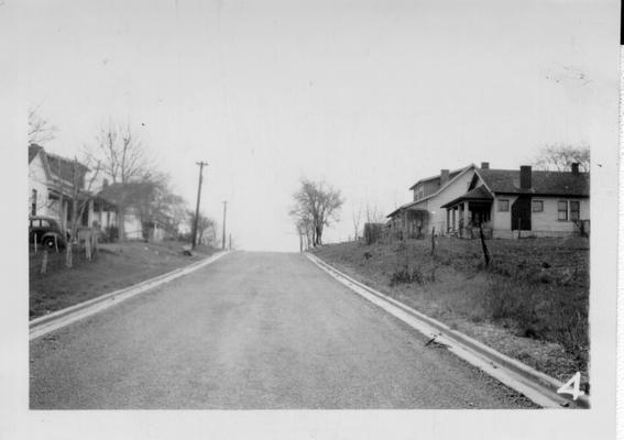 New street, curb and gutter rounded in front of first house on left in Winchester, KY 1940
