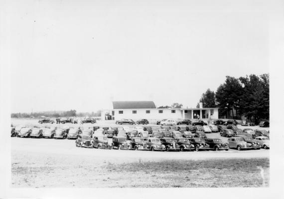 Parking lot showing automobiles during dedication of Madisonville Golf Course, May 30, 1941
