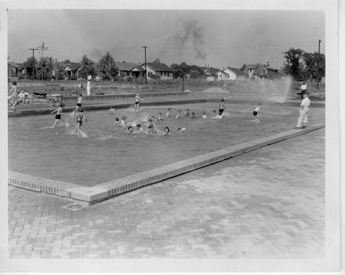 Children playing in wading pool at Algonquin Park Playground