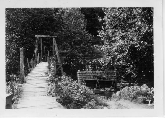 Carr Creek School swinging bridge. Pier of new bridge being built by National Youth Administration