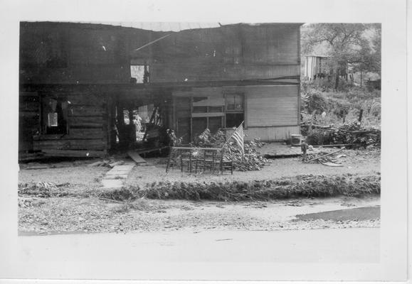 House damaged by flash flood of July 9, 1942. Note small American flag flying in front yard