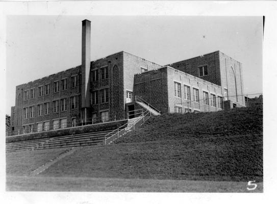 Terrace and bleachers on athletic field with West Liberty School in background