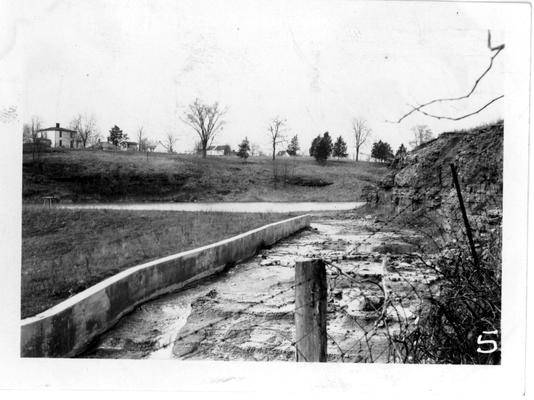 Water eroding retaining wall of spillway at Bardstown Lake