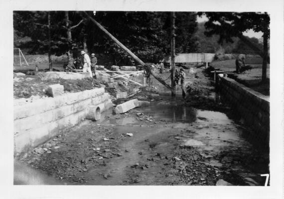 Building retaining wall along bank of creek flowing thru Morehead Teacher's College campus