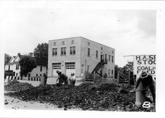 WPA sewer installation in Monticello with City Hall and Fire Station in the background