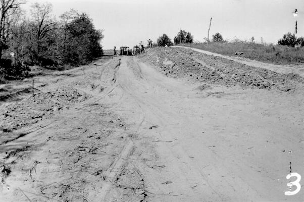 Project #2 District 1: Construction of the Clay to Bordley highway. This project involves the grading and draining of approximately 5.5 miles of road. This project is sponsored by the State Highway Department who furnish majority of equipment and supplies. Section of road showing workmen loading loose earth into trucks