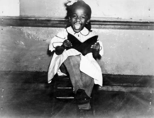 Project #205 District 6: Negro Women's Sewing Center. Small Negro girl clothed in garments made in the Negro Women's Training Work Center, Louisville, KY. Photographed February 19, 1936