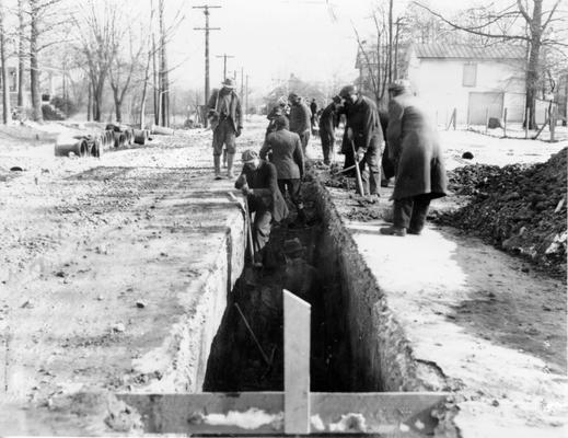 Project #2366 District 6: Construction of sewers in the 8th Ward, City of Louisville, KY. Digging sewer ditch. View shows respective depths of 6 feet, 4 feet, and 3 feet. Photographed January 21, 1936