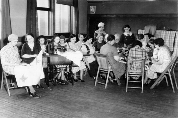 Project #1939 District 6: Recreational Activity Program in Louisville, KY. Group of mothers from needy families sewing at the Oakdale Center. This class is also under the direction of a WPA supervisor