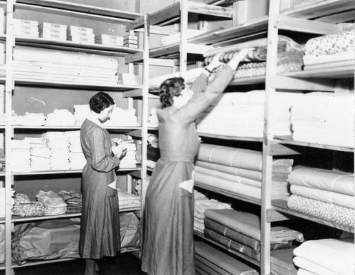 Project #215 District 2: Useful Articles are made in training work centers. WPA Project #215, which operates in Hardin County, provides Training Work Centers at Elizabethtown and Cecelia, where women from relief families are employed to make wearing apparel and other articles. The stock room of the Elizabethtown Training Work Center. Photographed March 20, 1936