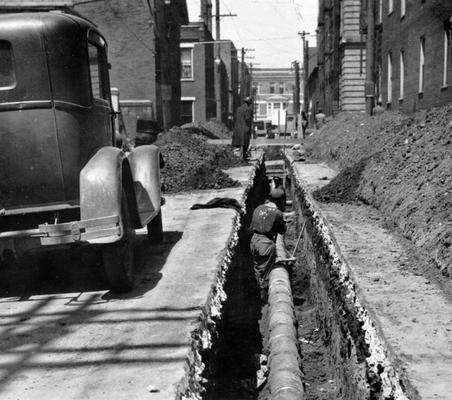 Project #2816 District 3: Sanitary sewer construction on various streets throughout the City of Lexington, KY. Installation of sanitary sewer on Church Street is shown in above view. Photographed April 22, 1936