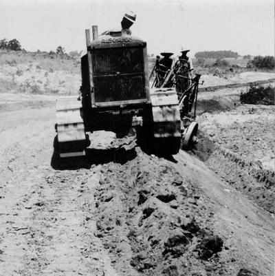 Project #543 District 2: Tractor and grader in operation during grading of 4 miles of road, beginning at Cave Ridge and extending to Echo by way of Liberty Church in Metcalfe County. This project also provides for draining and surfacing the road with gravel. Photograph was taken on June 5, 1936