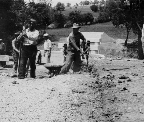 Project #48 District 2: Construction of a concrete bridge and the reconstruction of Forsyth Mill Road in Mercer County. The new bridge will replace an old wooden type bridge. View shows workers making out an approach to new bridge under construction. Photograph taken June 1, 1936