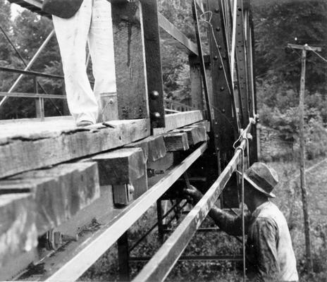 Project #759 District 2: Painting Bridges. Project #759 provides for repairing, cleaning and painting of three county owned bridges. View of this work in progress on one of the bridges is shown in photograph taken June 4, 1936