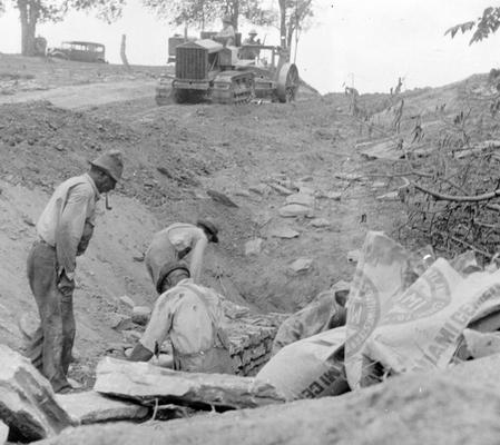 Project #831 District 4: Another view, photographed July 23, 1936, of the Goose Creek Road Project. This picture shows construction of a culvert in progress