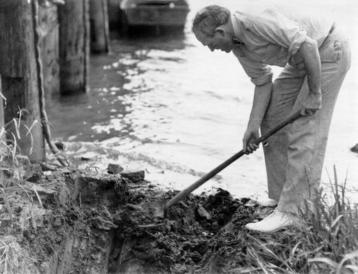 Project #110 District 6: Municipal Yacht Basin, Louisville, KY. Hon. Neville Miller, Mayor of Louisville, spading away dirt to permit water from the Ohio River to fill the City's Harbor for Pleasure Boats. This photograph was taken July 23, 1936