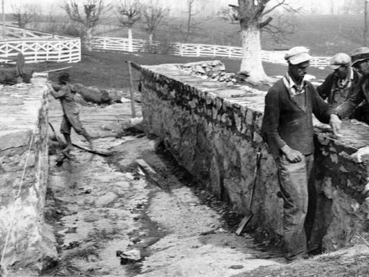 Project #778 District 2: Reconstruction of Fonthill-Wolfe Creek Road in Russell County is Project #778, now consolidated under Master Project #3313. Stone masonry culvert under construction on Fonthill-Wolfe Creek Road. View photographed April 16, 1936, shows sidewalls nearing completion