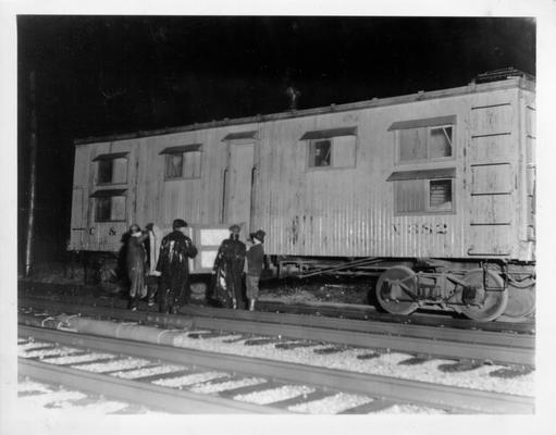 Men loading piece of furniture into railroad boxcar in Louisville, KY