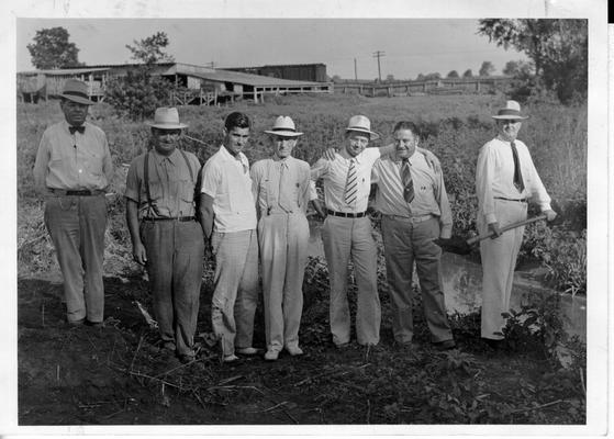 Lebanon Mayor Robert L. Spalding removing first shovel of dirt, July 21, 1941. (Left to right) L.W. Phillips, Street Superintendent; J.H. Walker, WPA Foreman; D.V. Terrell, Jr., Resident Engineer; R.L. Weatherford, County Judge; F.L. Chelf, County Attorney; L.T. Shepherd, WPA Superintendent; R.L. Spalding, Mayor