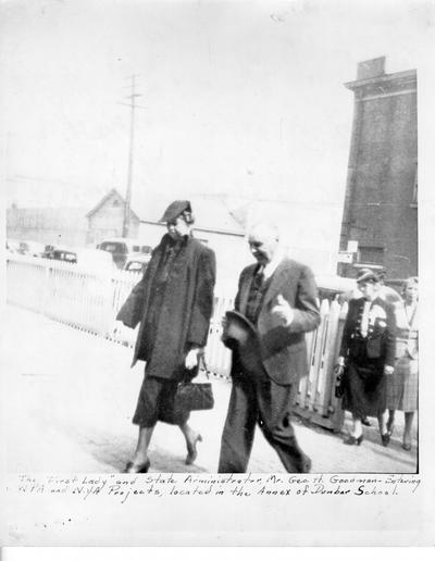 Eleanor Roosevelt and State WPA Administrator George H. Goodman entering Paul Dunbar Colored School at 9th and Magazine, Louisville, KY
