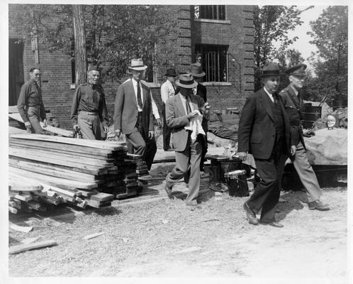 George H. Goodman, Colonel W.A. Danielson, General Adna R. Chaffee, and inspecting party emerging from Field Officers' Building under construction, May 18, 1939