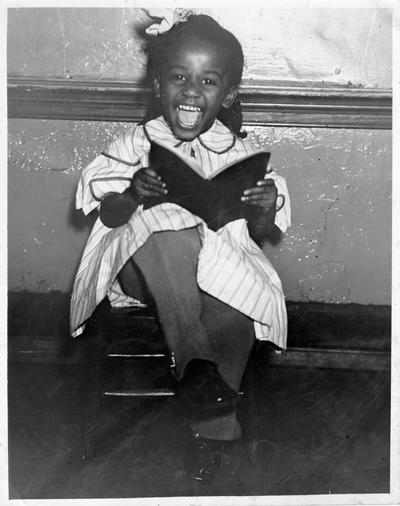 Clothing worn by this child made at the Training Work Center, Dunbar Colored School, 9th and Magazine, Louisville, KY. Picture taken at 