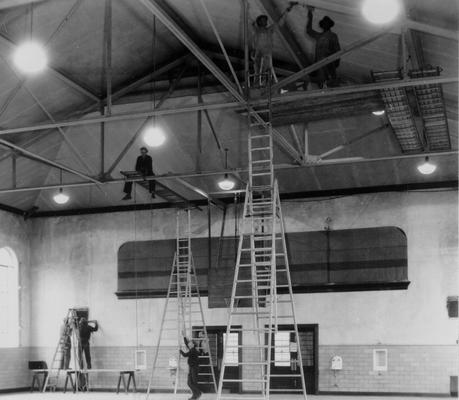 Project #674 District 6: No. 674 is a project providing for painting and renovating 55 structures in the Louisville Park System, including work on pavilions, shelter houses etc. Painting and renovating work in progress on the gymnasium at Phillips Lane and Crittenden Drive, Louisville, KY. Photographed November 15, 1935