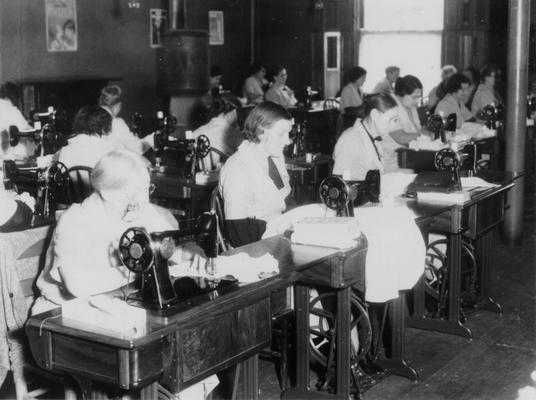 Project #275 District 6: Training Work Center at Shelby and Main streets, Louisville, where women are taught sewing, patching, household management, and child care. Finished articles are turned over to the project's sponsor for distribution to the needy. Work-rooms, showing sewing machine section. Machines rented by WPA in use