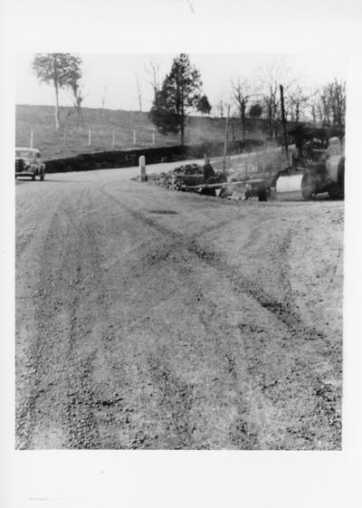 Project #363 District 3: Finishing K.E.R.A. Project No. 123-81-9, consisted of finishing masonry work and putting down concrete bridge on Watts Ferry Road, 10.5 miles west of Versailles. Also shouldering road running east from the bridge to Millville School, where road has been widened by blowing of part of the cliff. Completed section of Watts Ferry Road, showing new and old approaches to bridge. Photographed December 3, 1935