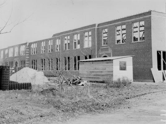 Project #168 District 1: Constructing and equipping a two-story brick school building at Heath, KY. Dimensions are 274' X 57'. Structure will house 21 classrooms, 2 toilets, shower and dressing rooms and the principal's office. View showing brick work with second story nearing completion. Photographed December 11, 1935