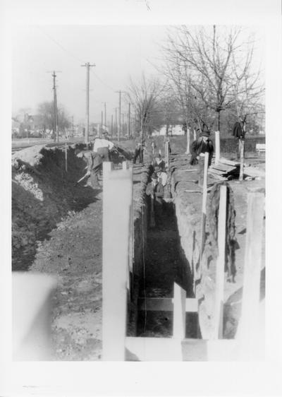 Project #1293 District 6: Construction of sewers in Ward No. 8, City of Louisville, KY. Back filling of trench after laying of sewer at Peck and Henry streets. Photographed December 12, 1935