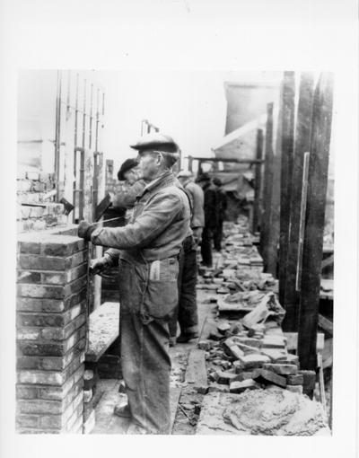 Project #481 District 6: Close-up view of bricklayers at University of Louisville Service Building, showing type of work accomplished with used brick. Photographed January 3, 1936