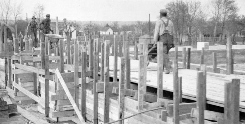Project #1384 District 1: Construction of a Health Building, housing an auditorium, a gymnasium and four classrooms, on the high school grounds at Greenville, KY. This structure will be one-story high and constructed of brick. View, photographed March 30, 1936, shows foundation walls practically completed