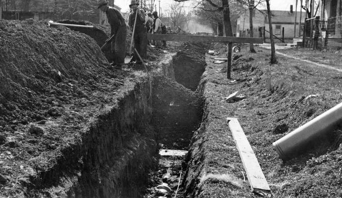Project #1163 District 3: Installation of an 8-inch sanitary sewer system in the City of Taylorsville, KY. View photographed March 26, 1936, shows workmen refilling trench after installation of sewer pipe