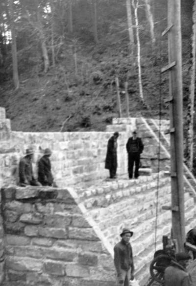 Project #596 District 4: Improvement of the county recreational camp at Watts Creek Settlement, Harlan County, KY. The improvements include repairing stone masonry dam and the construction of a mess hall, a caretaker's cabin, and a recreational hall, all of native materials. View of the reconstructed dam was photographed March 12, 1936
