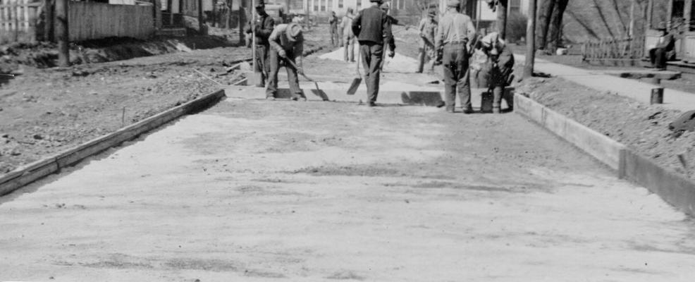 Project #486 District 1: Construction of cement bound macadam streets in the City of Princeton, KY. The coarse aggregate for this work is being furnished from the city rock crusher, which is set up in this project. Workmen shown preparing sub-grade for the new cement bound macadam streets in the City of Princeton. Photographed March 3, 1936