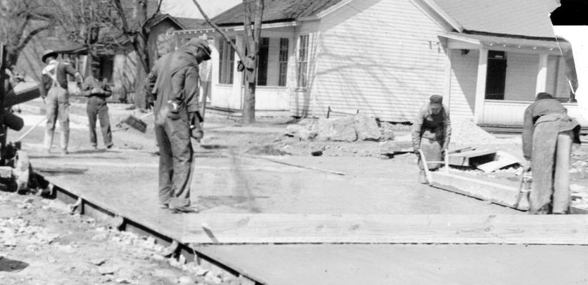 Project #486 District 1: Construction of cement bound macadam streets in the City of Princeton, KY. Workmen tamping the cement into a coarse aggregate. Photographed March 3, 1936