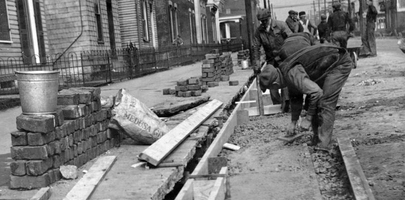 Project #2510 District 3: Construction of curb and gutter on Eleventh Street in the City of Newport, KY, was started February 8, 1936 under WPA Project #2510. Finishing surface of concrete gutter. Photographed March 6, 1936