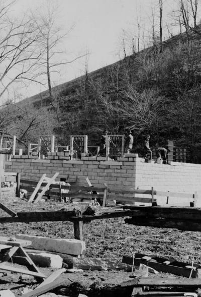 Project #587 District 5: Construction of a stone masonry jail building is under way at Hindman, KY. This work was begun under K.E.R.A. program. Workmen laying native stone walls of the jail at Hindman. Photographed February 28, 1936