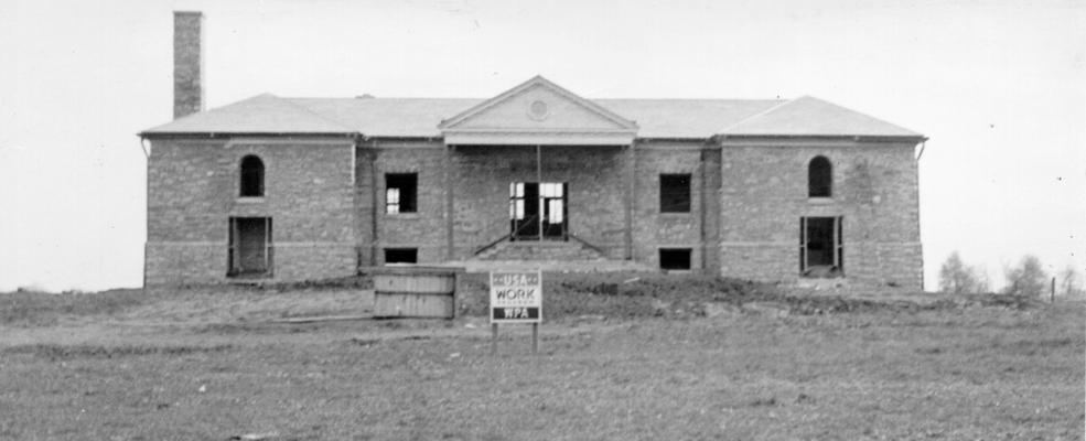 Project #177 District 3: Construction of a native stone county school building in Fayette County on Briar Hill Road, 8 miles northeast of Lexington, KY. Front view of the building, photographed May 1, 1936, shows structure near completion